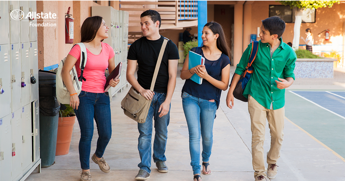 Four teenagers walking between classes.