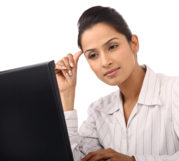 A woman looks at her computer