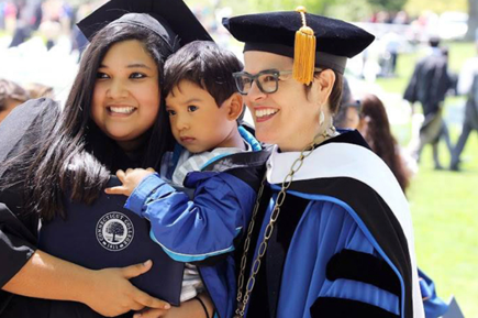 Laura Garciduenas poses at her college graduation with her son and Connecticut College President Katherine Bergeron.